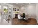 Elegant dining room with wine storage, hardwood floors, and stylish chandelier at 122 Beaufain St # C, Charleston, SC 29401