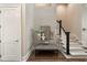 View of an entryway featuring stairs with carpeted steps, a display table and a white door at 122 Beaufain St # C, Charleston, SC 29401