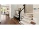Inviting entryway featuring hardwood floors, a staircase with carpet runner, and elegant decor at 122 Beaufain St # C, Charleston, SC 29401