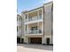 Multi-level townhome featuring balconies on each level over the stained-wood garage door at 122 Beaufain St # C, Charleston, SC 29401