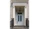 Close up of the entrance to a brick townhouse, showing the white front door and overhead light at 122 Beaufain St # C, Charleston, SC 29401