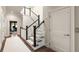 Hallway featuring stairs with carpeted steps, dark stained handrail and access to a home elevator at 122 Beaufain St # C, Charleston, SC 29401