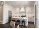 Bright kitchen featuring an island with seating, modern appliances, and custom cabinetry at 122 Beaufain St # C, Charleston, SC 29401