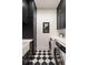 Modern laundry room with black and white checkerboard floors and appliances at 122 Beaufain St # C, Charleston, SC 29401