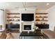 Inviting living room with hardwood floors, built-in shelving, fireplace, and modern lighting fixtures at 122 Beaufain St # C, Charleston, SC 29401