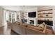 Elegant living room with hardwood floors, built-in shelving, a fireplace, and large windows with natural light at 122 Beaufain St # C, Charleston, SC 29401