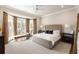 Primary bedroom featuring a bay window, neutral decor, and hardwood floors at 122 Beaufain St # C, Charleston, SC 29401