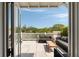 Spacious patio with outdoor furniture overlooking lush greenery and blue sky at 122 Beaufain St # C, Charleston, SC 29401
