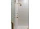 Shower showcasing detailed gold fixtures and bright white subway tiling with glass enclosure at 122 Beaufain St # C, Charleston, SC 29401