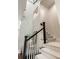 Staircase featuring white risers, herringbone carpet, black stained handrail and white banisters at 122 Beaufain St # C, Charleston, SC 29401