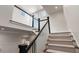 Elegant staircase with carpeted steps, white railings, and dark wood accents at 122 Beaufain St # C, Charleston, SC 29401