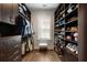 Well-organized walk-in closet featuring custom shelving, drawers, and hardwood flooring at 122 Beaufain St # C, Charleston, SC 29401