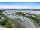An aerial view captures waterfront homes with private docks along a serene marsh at 1234 Captain Rivers Dr, Charleston, SC 29412