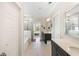 Bright bathroom with white tiled floors, double vanity, soaking tub, and shower with glass surround at 1234 Captain Rivers Dr, Charleston, SC 29412