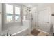 Bright bathroom features a soaking tub and glass-enclosed shower with rain shower head and natural light at 1234 Captain Rivers Dr, Charleston, SC 29412