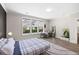 Bright bedroom features a desk near the windows and a bed with gray accents and natural light at 1234 Captain Rivers Dr, Charleston, SC 29412