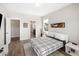 Comfortable bedroom with a modern design, wood floors, and stylish black and white patterned bedding at 1234 Captain Rivers Dr, Charleston, SC 29412