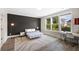 Stylish bedroom with modern lighting, a large rug, a wall-to-wall window and gray accent wall at 1234 Captain Rivers Dr, Charleston, SC 29412