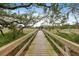 A wooden dock with moss-covered trees and marsh views creates a tranquil atmosphere at 1234 Captain Rivers Dr, Charleston, SC 29412