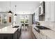 Spacious kitchen with an island, stainless appliances, white cabinets and an adjacent dining area at 1234 Captain Rivers Dr, Charleston, SC 29412