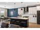 Open kitchen with a center island, counter seating, white cabinets, and stainless steel appliances at 1234 Captain Rivers Dr, Charleston, SC 29412