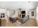Bright, open living area with fireplace, stairs, and connection to a well-equipped kitchen at 1234 Captain Rivers Dr, Charleston, SC 29412