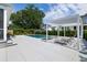 A modern rectangular pool with a white pergola and lounge chairs creates a relaxing backyard retreat at 1234 Captain Rivers Dr, Charleston, SC 29412