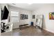 Bright workout room with a weight bench, mirror, television, and art at 1234 Captain Rivers Dr, Charleston, SC 29412