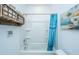 Bathroom with bathtub, blue shower curtain, decorative painting, and shelf for storage at 1242 Allusion Ln # 206, Mount Pleasant, SC 29466