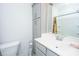 Bright bathroom featuring grey cabinets, a shower with tub, a toilet, and sink at 1242 Allusion Ln # 206, Mount Pleasant, SC 29466