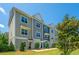 Stylish townhome exterior showing modern architecture, tidy landscaping, and a clear blue sky at 1242 Allusion Ln # 206, Mount Pleasant, SC 29466