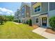 Well-maintained townhome exterior with landscaped yard and covered entryways at 1242 Allusion Ln # 206, Mount Pleasant, SC 29466