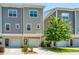 Townhome exterior with attached garage, landscaped yard, and modern architectural details at 1242 Allusion Ln # 206, Mount Pleasant, SC 29466