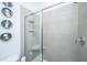 Contemporary bathroom shower with gray tile, a built-in seat, and sleek glass door at 1242 Allusion Ln # 206, Mount Pleasant, SC 29466