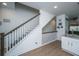 Elegant staircase with white railings and hardwood floors leading to the upper level at 1242 Allusion Ln # 206, Mount Pleasant, SC 29466