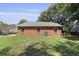 A well-maintained backyard featuring a lush lawn and a brick exterior with multiple windows at 1308 Cadet Ct, Mount Pleasant, SC 29466