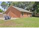 A beautiful backyard with a well-kept lawn, brick exterior, and a cozy seating area at 1308 Cadet Ct, Mount Pleasant, SC 29466