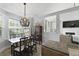 Dining area with stylish chandelier, wood table and chairs, and large window at 1308 Cadet Ct, Mount Pleasant, SC 29466