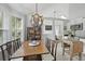 Dining area with stylish chandelier, wood table and chairs, and large window at 1308 Cadet Ct, Mount Pleasant, SC 29466