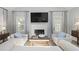Bright living room featuring a fireplace, large TV, and views of the outdoors at 1308 Cadet Ct, Mount Pleasant, SC 29466