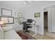 Modern home office setup with dual monitors, adjustable desk, and a cozy sofa area at 1308 Cadet Ct, Mount Pleasant, SC 29466