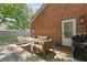 A cozy outdoor patio area with seating, a table, and a grill, perfect for entertaining at 1308 Cadet Ct, Mount Pleasant, SC 29466