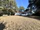 Spacious backyard with a patio, exterior access, and mature trees at 1329 Camp Rd, Charleston, SC 29412