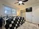 Cozy bedroom featuring a ceiling fan, a TV, closet and black and white bedding at 1329 Camp Rd, Charleston, SC 29412