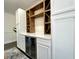 Built-in dry bar with wine rack, mini fridge, and white cabinets at 1329 Camp Rd, Charleston, SC 29412
