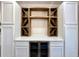 Built-in dry bar with wine rack, mini fridge, and white cabinets at 1329 Camp Rd, Charleston, SC 29412