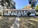 Charming home with a manicured lawn, a symmetrical facade, and a walkway leading to the front entrance at 1329 Camp Rd, Charleston, SC 29412