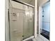 Shower with glass doors, a silver shower frame, and white shower walls at 1329 Camp Rd, Charleston, SC 29412