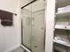White shower with glass doors and built-in shelving at 1329 Camp Rd, Charleston, SC 29412