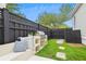 Backyard patio with built-in seating, a grilling area, stone pathway, and a black privacy fence at 1474 Blue Cascade Dr, Mount Pleasant, SC 29464